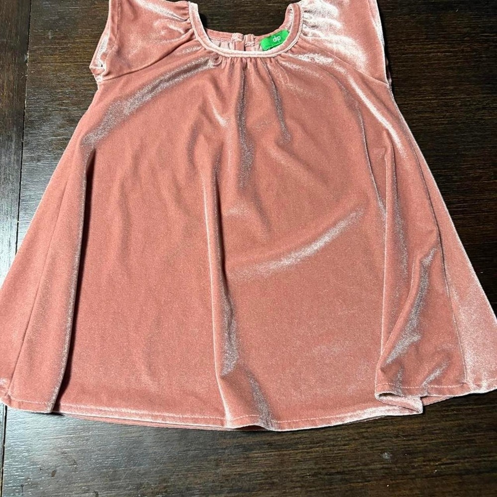 Pink velvet baby dress with ruffle detail.